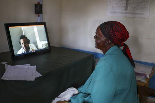 epa13273978 (FILE) - Mary Gachambi, (R), a 70-years old diabetic patient attends a consultation with a virtual doctor, on screen,  (C), located 140km away in Nairobi via a telemedicine technology at a remote village dispensary in Muranga, Kenya, 27 September 2024 (reissued on 01 October 2026). 01 October marks the United Nations International Day of Older...