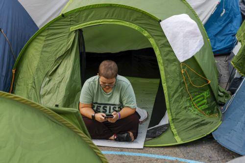 epa13274041 A demonstrator sits in a tent at a housing protest encampment at Puerta del Sol in Madrid, Spain, 01 October 2026. The encampment began late 26 September evening, following a demonstration in central Madrid protesting the eviction of Maricarmen - an elderly woman forced to leave her rental home after 70 years - and demanding effective measures...
