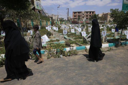 epa13277427 Women pass portraits on the graves of slain Houthi fighters after visiting the grave of a relative at a cemetery dedicated to those who were killed in Yemen's prolonged conflict, in Sana'a, Yemen, 02 October 2026. Yemen has been at risk of rupture again amid escalating fighting along the country’s Red Sea coastal areas near the Bab al-Mandeb...