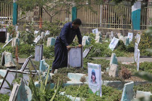 epa13277431 A person holds the portrait on the grave of a relative at a cemetery dedicated to those who were killed in Yemen's prolonged conflict, in Sana'a, Yemen, 02 October 2026. Yemen has been at risk of rupture again amid escalating fighting along the country’s Red Sea coastal areas near the Bab al-Mandeb Strait between Saudi-backed government forces...