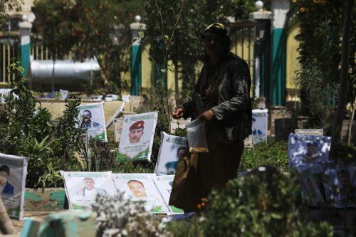 epa13277434 A person walks past portraits on the graves of slain Houthi fighters at a cemetery dedicated to those who were killed in Yemen's prolonged conflict, in Sana'a, Yemen, 02 October 2026. Yemen has been at risk of rupture again amid escalating fighting along the country’s Red Sea coastal areas near the Bab al-Mandeb Strait between Saudi-backed...