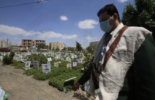 epa13277437 A person walks past portraits on the graves of slain Houthi fighters at a cemetery dedicated to those who were killed in Yemen's prolonged conflict, in Sana'a, Yemen, 02 October 2026. Yemen has been at risk of rupture again amid escalating fighting along the country’s Red Sea coastal areas near the Bab al-Mandeb Strait between Saudi-backed...