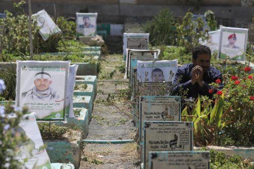 epa13277441 A person sits next to the grave of a relative at a cemetery dedicated to those who were killed in Yemen's prolonged conflict, in Sana'a, Yemen, 02 October 2026. Yemen has been at risk of rupture again amid escalating fighting along the country’s Red Sea coastal areas near the Bab al-Mandeb Strait between Saudi-backed government forces and the...