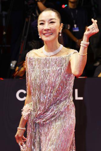 epa13286106 Malaysian star Michelle Yeoh forms the shape of a heart with her fingers as she walks to enter the opening ceremony of the 31st Busan International Film Festival (BIFF) at the outdoor theater of the Busan Cinema Center in Busan, South Korea, 06 October 2026 (issued 07 October 2026). The festival began its 10-day run after the International...