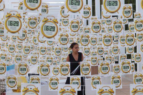 epa13286415 Anti-government protesters hangs signs that read in Hebrew: '6:29 time to wake up', referring to the start time of the 07 October 2023 Hamas-led attacks, at Habima square in Tel Aviv, Israel, 07 October 2026.  EPA/ABIR SULTAN