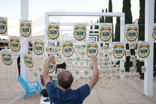 epa13286418 Anti-government protesters hangs signs that read in Hebrew: '6:29 time to wake up', referring to the start time of the 07 October 2023 Hamas-led attacks, at Habima square in Tel Aviv, Israel, 07 October 2026.  EPA/ABIR SULTAN