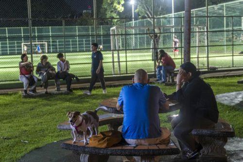 epa13293161 People wait in a park after a magnitude 7.7 earthquake struck southeastern Panama, in Panama City, Panama, 9 October 2026. The Geosciences Institute (IGC) reported that more than a hundred aftershocks have followed the magnitude 7.5 to 7.7 earthquake that struck the southeast of the country, while civil protection sources report at least two...