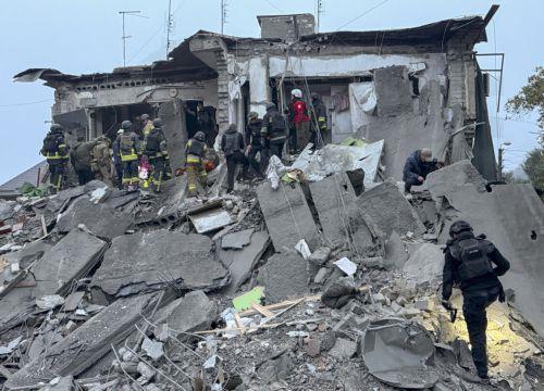 epa13293552 Ukrainian rescuers work at the site of a Russian attack on a residential area in Zaporizhzhia, Ukraine, 10 October 2026, amid the ongoing Russian invasion. At least five people, including two children, were killed and 11 others injured in overnight Russian strikes on the residential area, according to the State Emergency Service.  EPA/DARYNA...