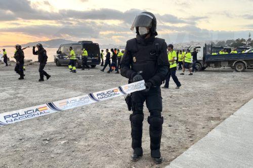 epaselect epa13295933 A Spanish National Police officer seal off the area during the clearing of a migrant camp set up in the esplanade in front of the old El Guano factory in Ceuta, Spain, 11 October 2026. Police carried out the new operation just over 48 hours before an official visit by the Spanish royal couple to the Spanish enclave in North Africa. ...
