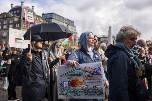 epa13296362 Demonstrators participate in a national protest in support of the Palestinian people on Dam Square in Amsterdam, the Netherlands, marking the conclusion of a nationwide week of action calling for sanctions against Israel, 11 October 2026. According to various activist groups, despite the 'ceasefire', the genocide against the Palestinian people...