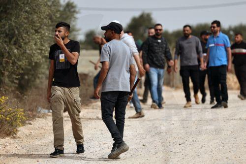 epa13309142 Palestinians remain on alert following a settlers' attack on families harvesting their olive trees in Abu Falah, West Bank, 16 October 2026. According to Wafa, several Palestinians and a foreign journalist were injured in Israeli settler attacks on residents and olive pickers up to 3 locations in the central West Bank.  EPA/ATEF SAFADI
