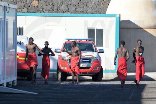 epa13315096 Sub-Saharan migrants, who were rescued by the Rescue Navy while attempting to reach Spain, wait to get assistance from Red Cross members, at La Restinga dock in El Hierro, Canary Islands, Spain, 19 October 2026. A total of 145 Sub-Saharan migrants were rescued off the shore while attempting to reach Spain.  EPA/Gelmert Finol