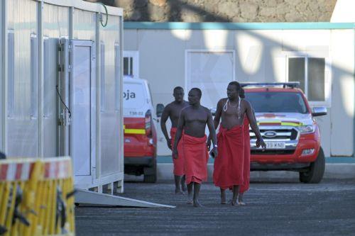 epa13315098 Sub-Saharan migrants, who were rescued by the Rescue Navy while attempting to reach Spain, wait to get assistance from Red Cross members, at La Restinga dock in El Hierro, Canary Islands, Spain, 19 October 2026. A total of 145 Sub-Saharan migrants were rescued off the shore while attempting to reach Spain.  EPA/Gelmert Finol
