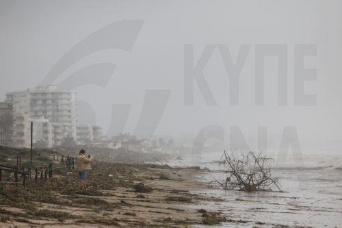 epa13315374 A person looks at the damage caused by Storm Adam in Guardamar de la Safor, Valencia, Spain,19 October 2026. Adam Storm has already claimed two lives and is causing 'extraordinary' rainfall and severe flooding in Valencia and Alicante, with rainfall totals exceeding 600 litres per square metre, rivers bursting their banks and people trapped on...