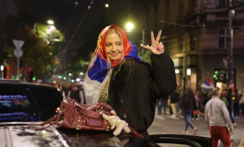 epaselect epa13331984 A supporter of the 'Student List' celebrates after the parliamentary elections in Belgrade, Serbia, 25 October 2026. Roughly 6.5 million eligible voters were called to the polls in a snap parliamentary election to choose lawmakers for a four-year term.  EPA/ANDREJ CUKIC