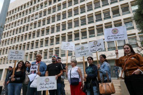epa13336276 Bank customers and members of the Depositors Association carry placards during a protest organized by the Union of Lebanese Expatriates Depositors, a group campaigning for depositors' rights, in Beirut, Lebanon, 28 October 2026. Protesters gather outside the Lebanese Central Bank to oppose the financial regularization plan and denounce the...