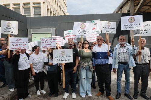 epa13336277 Bank customers and members of the Depositors Association carry placards during a protest organized by the Union of Lebanese Expatriates Depositors, a group campaigning for depositors' rights, in Beirut, Lebanon, 28 October 2026. Protesters gather outside the Lebanese Central Bank to oppose the financial regularization plan and denounce the...