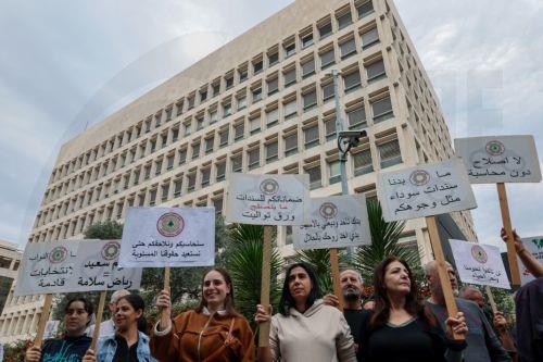 epa13336278 Bank customers and members of the Depositors Association carry placards during a protest organized by the Union of Lebanese Expatriates Depositors, a group campaigning for depositors' rights, in Beirut, Lebanon, 28 October 2026. Protesters gather outside the Lebanese Central Bank to oppose the financial regularization plan and denounce the...