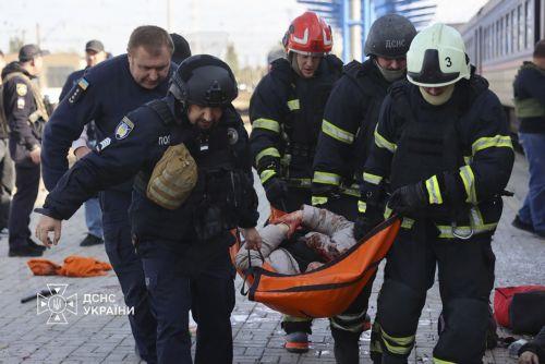 epa13339250 A handout photo released by the press service of the State Emergency Service (SES) of Ukraine shows Ukrainian rescuers evacuating an injured person at the site of a Russian drone strike on a platform at the railway station in Dnipro, central Ukraine, 29 October 2026, amid the Russian invasion. At least 14 people were killed and 14 others injured...