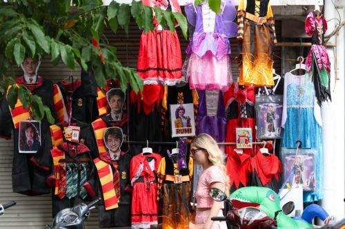 epa13340456 A woman walks past a store selling Halloween decorations and costumes in Hanoi, Vietnam, 30 October 2026. Halloween is celebrated annually on 31 October and has gained increasing popularity among younger generations in Vietnam.  EPA/LUONG THAI LINH