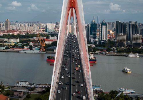 epa13341194 (FILE) - An aerial photo taken with a drone shows  the bridge over the Huangpu River in Shanghai, China, 15 August 2023 (reissued on 30 October 2026). 31 October, Fuzhou (China) will host World Cities Day 2026, focusing on how cities can renew their neighborhoods while ensuring adequate and affordable housing for all.  EPA/ALEX PLAVEVSKI