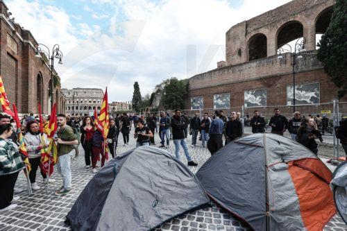 epa13341512 People take part in a demonstration at Imperial Fora, at the foot of the Colosseum, during a general strike organized by the USB Piemonte union in Rome, Italy, 30 October 2026. Workers and students protest against war, the economic situation, and the rising cost of living.  EPA/GIUSEPPE LAMI