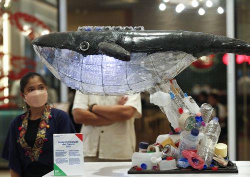 epa10207130 A visitor looks at a 'trash to treasure' art installation displayed at the Sustainability Expo 2022 in Bangkok, Thailand, 26 September 2022. The Sustainability Expo 2022 is being hosted to support the country's target of sustainable development goals by 2030, with hundreds of international and domestic companies exhibiting their sustainable...
