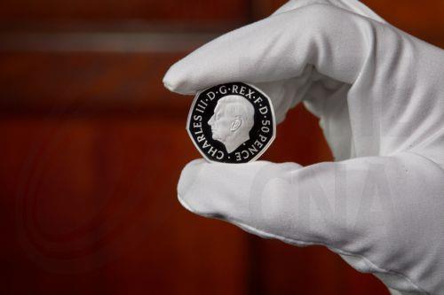 epa10214859 A handout photo made available by the British Royal Mint, London, Britain 30 September 2022 unveiling the official coin effigy of His Majesty King Charles III. The first coins to bear The Kingâ€™s portrait are a special Â£5 Crown and 50 pence (shown) commemorating the life and legacy of Her Late Majesty Queen Elizabeth II.  EPA/TOM HARRISON...
