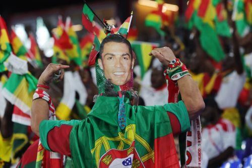 epa10325324 A fan of Portugal wears a hat with the face of Cristiano Ronaldo and the flags of Portugal and Ghana ahead of the FIFA World Cup 2022 group H soccer match between Portugal and Ghana at Stadium 947 in Doha, Qatar, 24 November 2022.  EPA/Abir Sultan