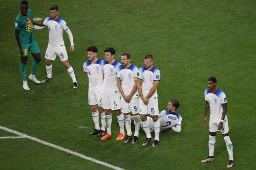 epa10348825 Jack Grealish of England lies on the ground as part of the wall with his teammates before a free kick during the FIFA World Cup 2022 round of 16 soccer match between England and Senegal at Al Bayt Stadium in Al Khor, Qatar, 04 December 2022.  EPA/Rolex dela Pena