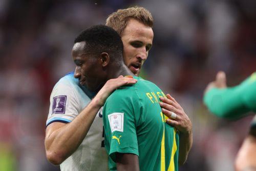epa10348872 Harry Kane (L) of England and Pape Matar Sarr of Sengal react after the FIFA World Cup 2022 round of 16 soccer match between England and Senegal at Al Bayt Stadium in Al Khor, Qatar, 04 December 2022.  EPA/Tolga Bozoglu