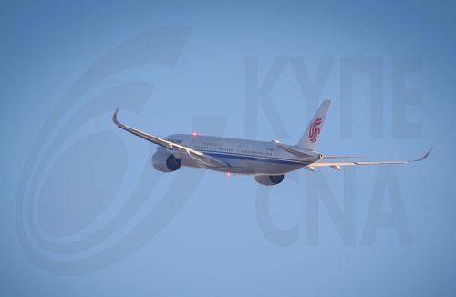 epa10394888 An Air China airplane flies over the Beijing Capital International Airport in Beijing, China, 08 January 2023. China has reopened its borders and no longer requires quarantine for inbound travelers. The country's National Health Commission (NHC) has downgraded the management of COVID-19 from Class A to Class B as part of measures in reopening...