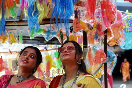 epa10500101 Customers look at party items at a market ahead of the Holi celebrations in Kolkata, India, 03 March 2023. Holi, also known as the Festival Of Colors, is an ancient Indian Hindu festival symbolizing the victory of good over evil and marking the arrival of spring. It is held annually with joyful gatherings during which revelers cover each other...