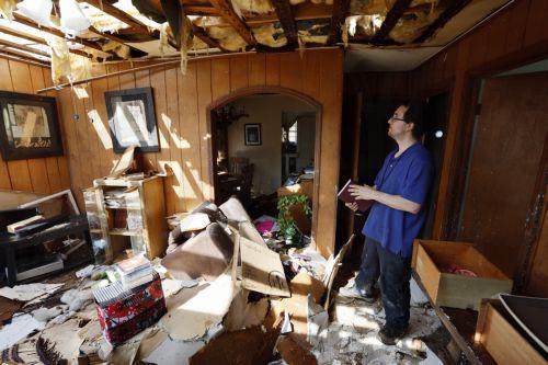 epa10546225 David Bennett goes through his damaged house in the wake of a tornado in West Point, Georgia, USA, 27 March 2023. Tornadoes were confirmed in Georgia on 26 March two days after at least 25 people were killed in Mississippi after a tornado and severe weather outbreak on 24 March, according to the Mississippi Emergency Management Agency.  EPA/ERIK...