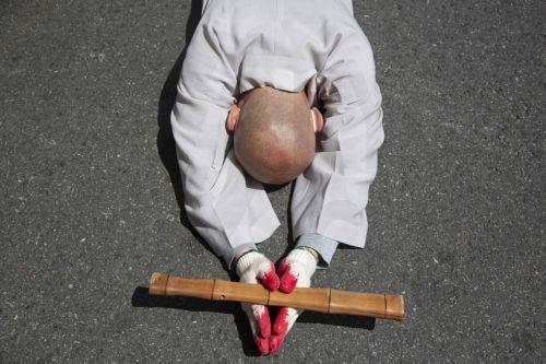 epa10614886 A South Korean monk performs the Buddhist praying act of Dharna - walking three steps and making one bow - to protest against Japan's disposal of Fukushima radioactive water during a rally against the visit of the Japanese prime minister in Seoul, South Korea, 08 May 2023. Japanese Prime Minister Fumio Kishida is on a visit to South Korea from...