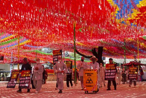epa10614891 South Korean monks perform the Buddhist praying act of Dharna - walking three steps and making one bow - to protest against Japan's disposal of Fukushima radioactive water during a rally against the visit of the Japanese prime minister in Seoul, South Korea, 08 May 2023. Japanese Prime Minister Fumio Kishida is on a visit to South Korea from 07...