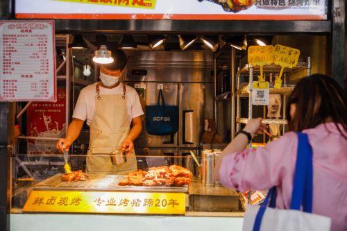 epa10617161 A vendor works in a barbecue shop in Beijing, China, 09 May 2023. China's trade surplus surged to 90.21 billion dollars in April 2023, from 49.47 billion in the same period the prior year. Exports rose by 8.5 percent year on year, while imports fell by 7.9 percent as domestic demand weakened.  EPA/WU HAO