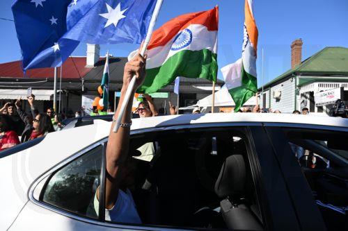 epa10646956 Members of the Indian community in the suburb of Harris Park celebrate in anticipation of a potential visit by India's Prime Minister Narendra Modi to what is known as Little India, in Sydney, Australia, 23 May 2023. Prime Minister Modi has an official engagement tonight with members of the Indian community at Qudos Bank Arena.  EPA/DEAN LEWINS...