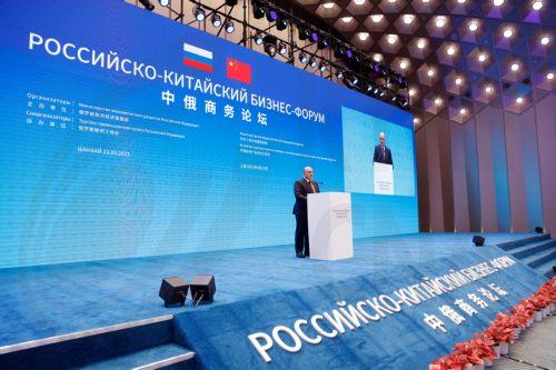 epa10647011 Russian Prime Minister Mikhail Mishustin speaks during a plenary session of the Russian-Chinese Business Forum in Shanghai, China, 23 May 2023. Mikhail Mishustin assured that Russia would continue to supply hydrocarbons to China on a long-term basis, and offered Beijing to cooperate in the field of engineering for the fuel and energy complex. ...