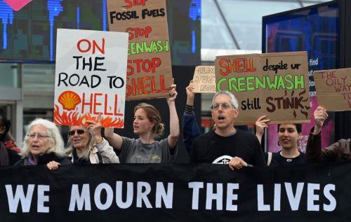 epa10647433 Demonstrators protest outside the Shell General Shareholders meeting at the Excel Centre in London, Britain, 23 May 2023. Scores of protesters managed to gain access to Shell's Annual General Meeting (AGM) before being carried or escorted out. Demonstrators are calling for Shell to be shut down stating the oil giant is a global pollutant. ...
