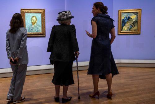 epa10669226 Princess Beatrix of the Netherlands (C) in conversation with museum director Emilie Gordenker (R) in front of a self-portrait (L) of Dutch painter Vincent van Gogh during a tour of the Van Gogh Museum in Amsterdam, the Netherlands, 02 June 2023. The museum is celebrating its 50th anniversary with a free Sunflower Art Festival on Museumplein and...