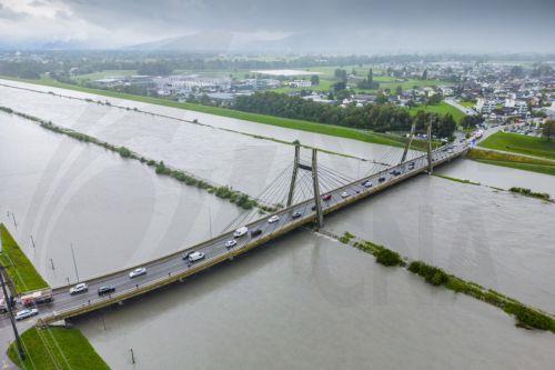 epa10825509 A picture taken with a drone shows waters of the Rhine river flooding some land between the dams after heavy rainfall in Diepoldsau, canton St. Gallen, Switzerland, 28 August 2023. Especially in the south and east of Switzerland, enormous sums of rain accumulated.  EPA/YANIK BUERKLI