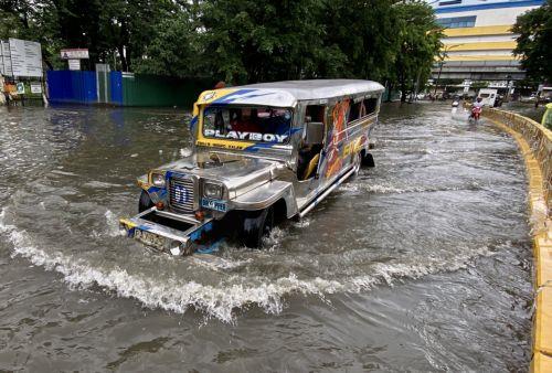 epa10830557 A jeepney maneuvers on a flooded street in Manila, Philippines, 31 August 2023. Typhoon Saola, which has left the Philippine Area of Responsibility, and Tropical Storm Haikui off the coast of extreme northern provinces are enhancing a southwest monsoon bringing rains in the western Luzon region of the country, according to data from the...