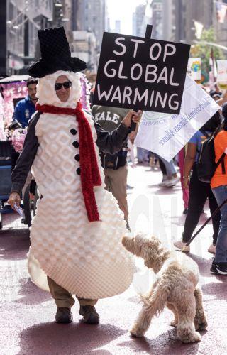 epa10867094 A man dressed as a snowman participates in the 'March to End Fossil Fuels', being held in advance of the United Nations' Climate Ambition Summit, in New York City, New York, USA, 17 September 2023. The Climate Ambition Summit 2023, convened by UN Secretary-General Antonio Guterres, will take place at the United Nations headquarters in New York...