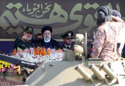 epa10876307 Iranian President Ebrahim Raisi listen to Iranian Islamic chief commander of Revolutionary Guard Corps (IRGC) General Hossein Salami during the annual military parade marking the Iraqi invasion in 1980, which led to an eight-year-long war (1980-1988), in Tehran, Iran, 22 September 2023.  EPA/ABEDIN TAHERKENAREH