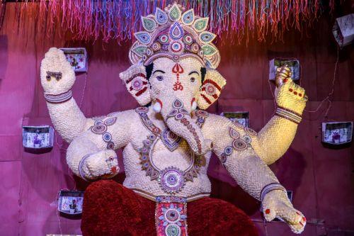 epa10876692 Indian devotees visit the twelve-feet long idol of elephant-headed Hindu god Lord Ganesha, made out with 36,000 woolen pom-poms, during the Ganesh Festival at the Sapurpada Sarvajanik Ganeshotsav Mandal, in Mumbai, India, 22 September 2023. The idol is presented as part of the ten-day long Ganesh Chaturthi festival celebrated all over India.The...