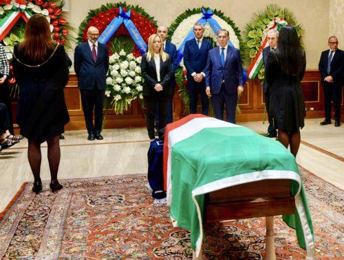 epa10880200 A handout picture made available by the Chigi Palace (Palazzo Chigi) Press Office shows Italian Premier Giorgia Meloni (C) paying respect at the coffin of late President Emeritus of the Republic Giorgio Napolitano laid in state in the Senate in Rome, Italy, 24 September 2023. Former Italian president Giorgio Napolitano died in a Rome clinic on...