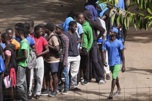 epa10909400 Migrants queue at 'Las Raices' reception center in La Laguna, Tenerife, Canary islands, Spain, 09 October 2023. The named center is housing most of the migrants rescued by Spain's rescue ships. The Canary Islands have received 4,531 migrants in nine days, an unprecedented rate since 2006.  EPA/ALBERTO VALDES
