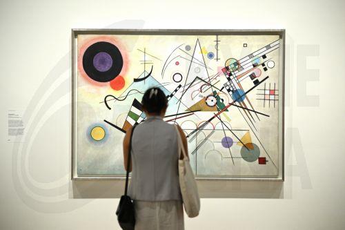 epa10955555 A patron looks at works of art during a media preview of the Sydney International Art Series 2023-24 Vasily Kandinsky exhibition at the Art Gallery of New South Wales in Sydney, Australia, 03 November 2023.  EPA/DAN HIMBRECHTS AUSTRALIA AND NEW ZEALAND OUT