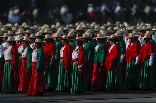 epa10986572 Women wearing typical clothes of the Mexican Revolution take part in the parade commemorating the 113 anniversary of the Mexican Revolution, at the Plaza Constitucion Square, in Mexico City, Mexico, 20 November 2023.  EPA/ISAAC ESQUIVEL
